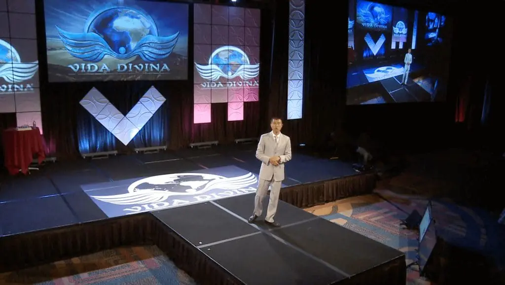 Simon Chan speaking at annual convention of Armand Puyolt's MLM company