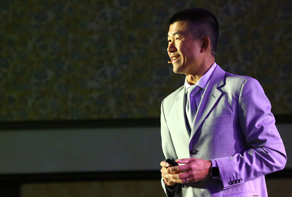 Simon Chan doing network marketing coaching from a live event